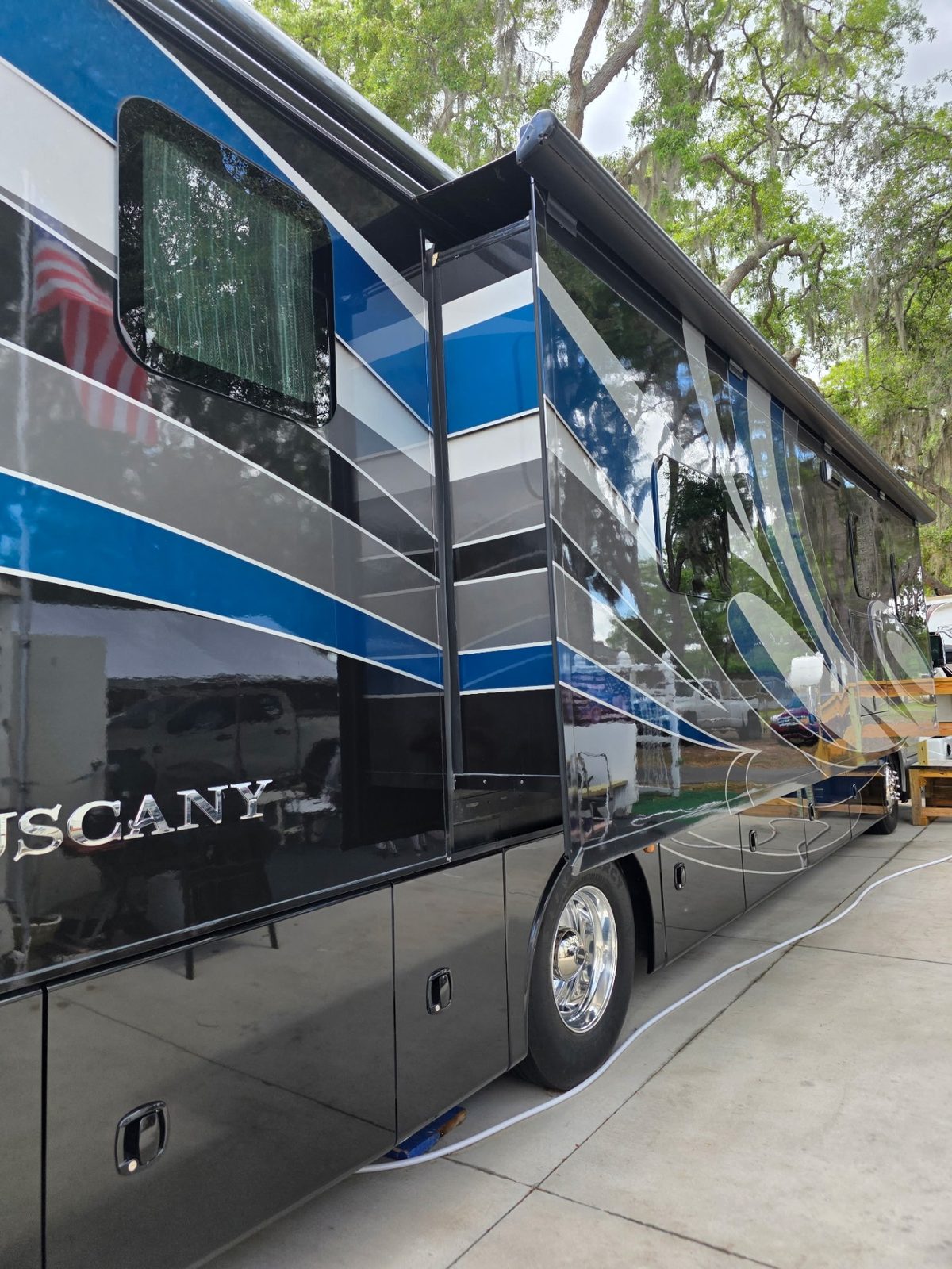 Glossy black and blue Tuscany Class A diesel pusher hand-washed by CamperKleen