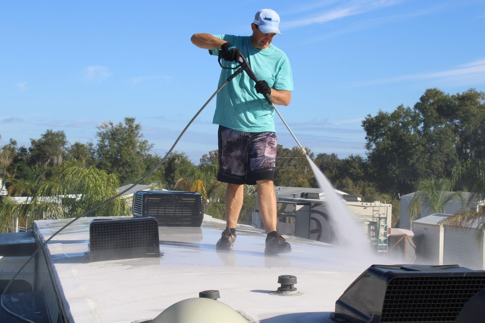 Jeff soft-washing an RV roof with a low-pressure wand